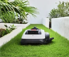 ECOVACS GOAT O1000 LiDAR PRO Robotic Mower — wire-free robotic mower, manufacturer photograph taken outdoors on a lawn