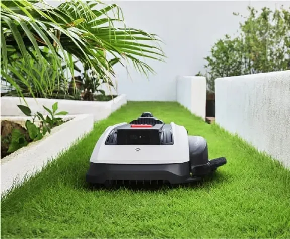 ECOVACS GOAT O1000 LiDAR PRO Robotic Mower — wire-free robotic mower, manufacturer photograph taken outdoors on a lawn