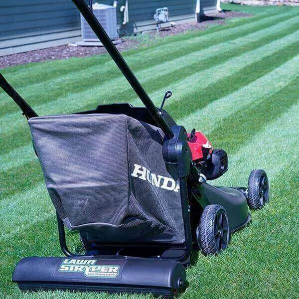Lawn Stryper Generation 3 (Honda 20–22 in) — mower striping roller attachment, manufacturer photograph taken outdoors on a lawn