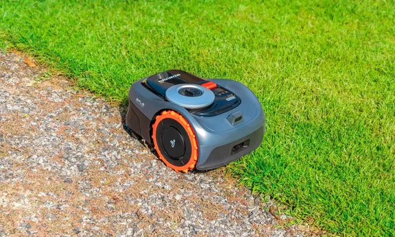 Segway Navimow i110N Robotic Mower — wire-free robotic mower, manufacturer photograph taken outdoors on a lawn