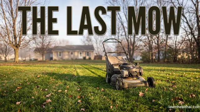 A push mower parked on a still-green lawn showing fresh mowing lines in low late-autumn sun, bare trees and scattered brown leaves around it and a house behind, with the words “The Last Mow” set across the top